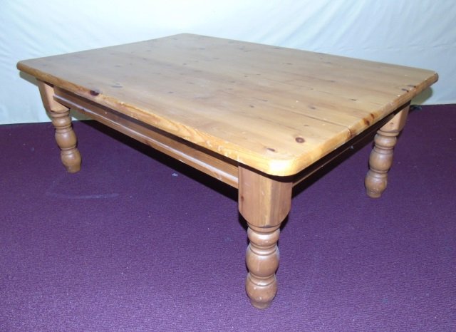Contemporary Knotty Pine Coffee Table: American country knotty pine coffee table. Turned legs. 47" W x 33" D x 18" H. Good condition.