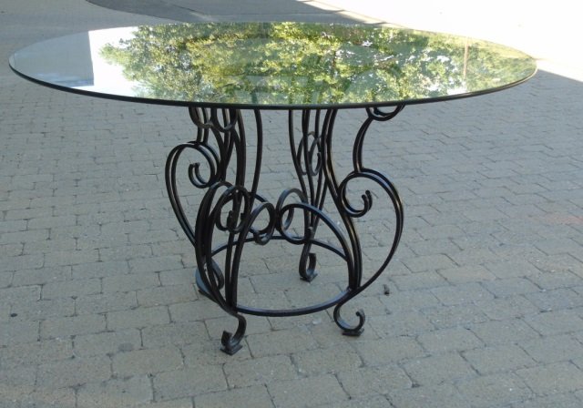 Black Wrought Iron Base, Glass Top Dining Table: Outdoor dining table, black wrought iron scroll base with glass top. 48" diameter x 30" H. Good condition.