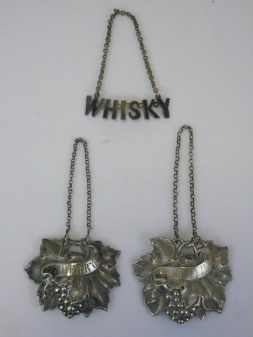 Sherry Whiskey & Port Wine Decanter Labels: Sherry Whiskey & Port Wine Decanter Labels. Silver or plate, unmarked. Largest measures 2.5 by 2.75 inches.