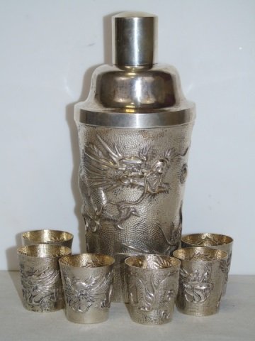 19th C. Chinese Silver Cocktail Shaker w/ Dragon: 19th century Chinese export silver cocktail shaker with dragon motif. Includes six shot glasses jiggers. Vermeil interior. 3" diameter. 8" high x 3" diameter.