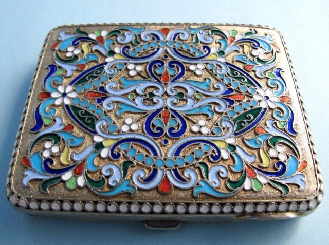 Imperial Russian Silver Enamel Cigarette Case: A 19th century Imperial Russian silver / gilt Cloisonne enamel cigarette box. Hallmarked for silver and maker. Measures 3.75 by 3 inches.