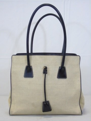 Prada Linen Handbag Purse with Leather Handles: Prada beige linen handbag purse with brown leather handles and detail. Two interior compartments. 12" W x 10" H x 4" D. Excellent condition. Includes dust bag.