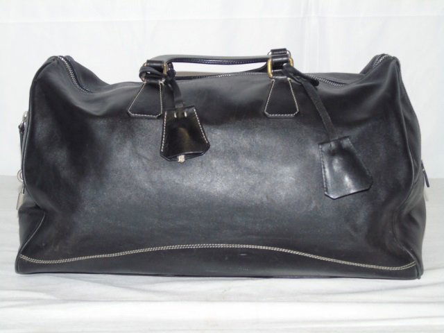 Prada Black Leather Satchel Handbag Purse: Prada black leather satchel handbag. Classic design. Zip closure. One interior zip pocket. Protective chrome feet. 16" W x 9" H x 7" D. Good condition. Includes dust bag.
