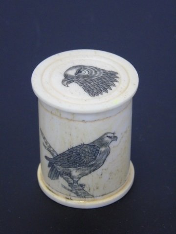 Carved Bone Eagle Pill or Snuff Box: Carved Bone Eagle Pill or Snuff Box. With carved scrimshaw style scenes of eagles. Measures 1.5 inches in height, 1.25 inches in diameter.