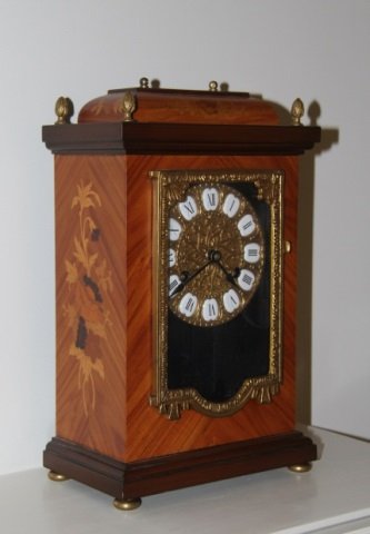 French Style Marquetry Inlay Ormolu Mantle Clock: French Style Marquetry Inlay Ormolu Mantle Clock. Porcelain and gilt face. Inlaid exterior. Front and back opening. Measures 13 inches in height, 9 inches in width, 5 inches in depth.