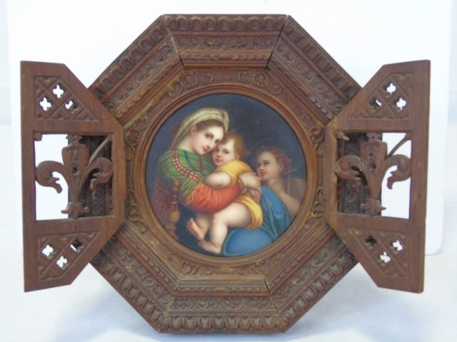 19th C. Painted Porcelain Madonna & Child: 19th century painted porcelain plaque of Madonna and child. Pose is after a Raphael oil painting. Intricate and unusual carved wood frame with doors. Gothic style.