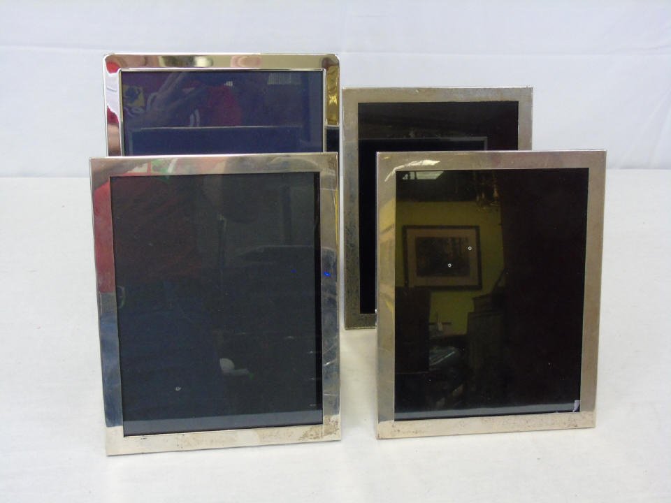 Lot of 4 Silver Picture Frames 3 Sterling: Lot of four silver picture frames. Simple elegant design. (3) are sterling, (1) is silver plate (3) are for photos 6 3/4" x 8 1/2". (1) is 8" x 10".