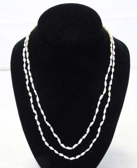 Estate Antique Seed Pearl & White Gold Necklace: Estate antique seed pearl and white gold filigree clasp necklace. Hand knotted and baroque seed pearl. Clasp hallmarked 14kt. Measures 41 inches in length.