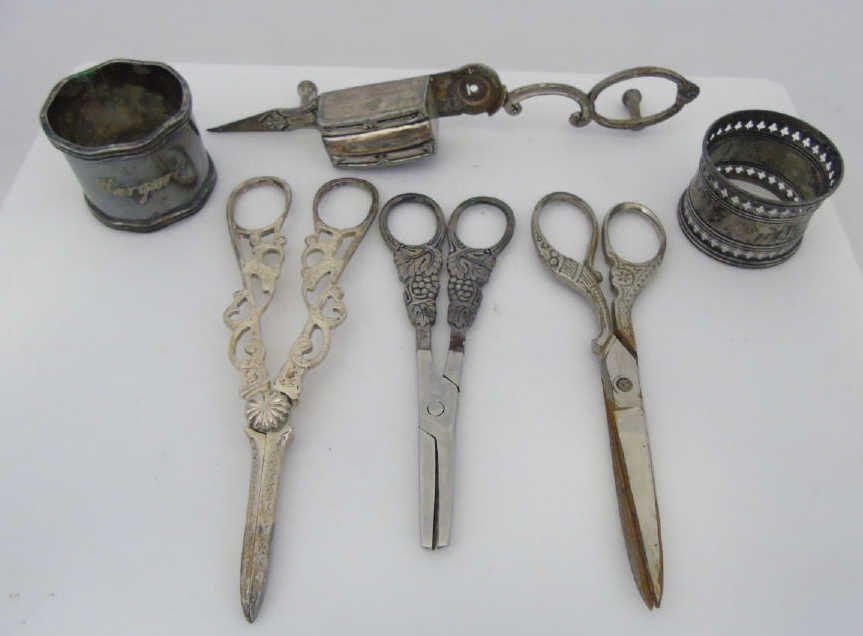 Sterling and Silver Napkin Rings and Cutters: Sterling and Silver Napkin Rings and Cutters. Sterling and Silver plate handle wick cutter, grape cutter and sewing scissors. Tiffany and Co. silver plate napkin ring and one Gorham Sterling silver na