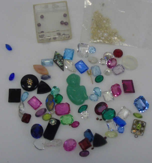 Large Assortment of Small Faceted Gemstones: Large Assortment of Small Faceted Gemstones. Natural and synthetic. Test as glass, topaz, spinel, onyx, jade, tourmaline. Various cuts, sizes and qualities.