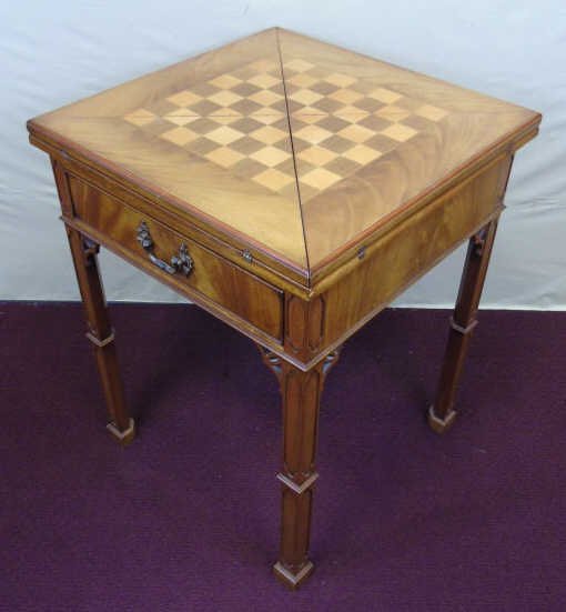 Contemporary Traditional Games Table: Contemporary Traditional Games Table. Folding top of four triangles opens and spins to create extended playing surface with checker board / chess top. Measures 31 inches in height, 25 inches wide and 