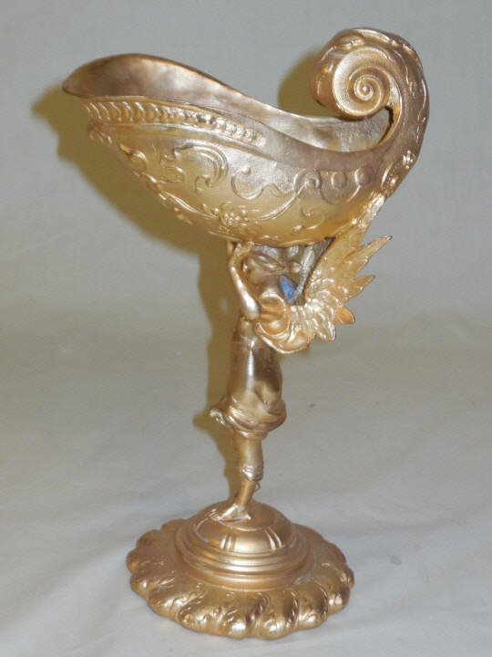 Gold Painted Chalice w/ Winged Goddess Stem: Gold painted metal decorative chalice with winged Goddess stem. Decorative purposes only. 7" W x 4 1/4" D x 10 5/8" H. In excellent condition.