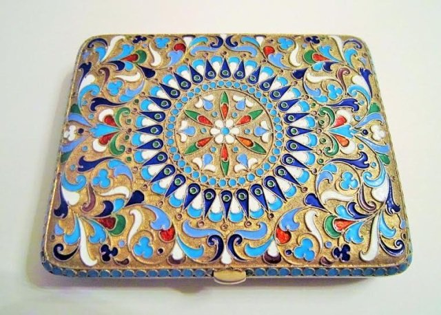 Imperial Russian Silver Cloisonne Enamel Cig Case: Imperial Russian gilded silver and cloisonne enamel cigarette case. The cigarette case with foliate and floral enamel design on both side. Round turquoise color jewels around both parts. Gilded interi