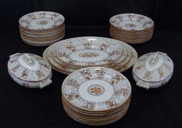 Antique English Ironstone Dinner Service: Large lot of English ironstone tableware. Lovely fall colors. 22 plates, 11 bowls both 10" diameter. Set of 4 nesting platters, largest is 19 1/2" x 16", smallest is 13" x 10". 2 tureens 11" long x 6 