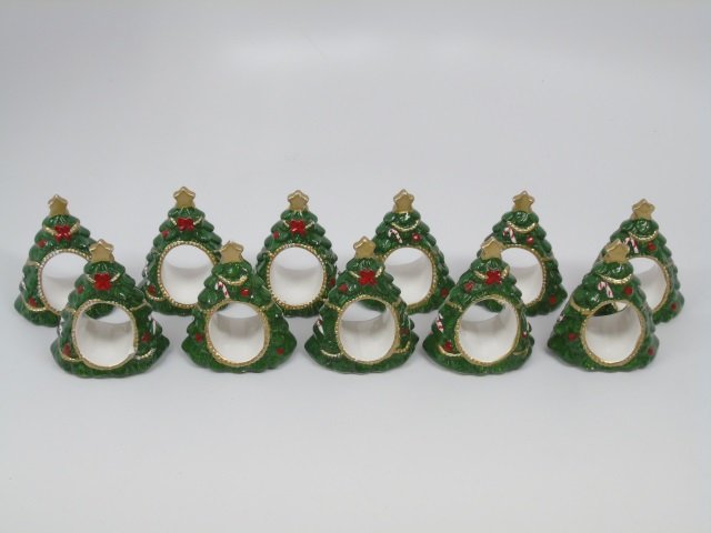 11 Painted Porcelain Christmas Tree Napkin Rings: Lot 11 Painted Porcelain Christmas Tree Napkin Rings. 2 1/2" W x 3" H.