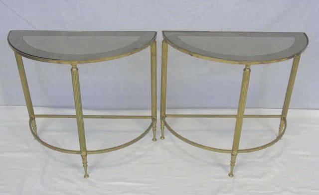 Pair of Brass Half Moon End Tables: Pair of Brass Half Moon End Tables. Smokey glass tops banded with mirror. Ribbed legs with stretcher. 18 1/2" W x 9 1/4" D x 17" H.