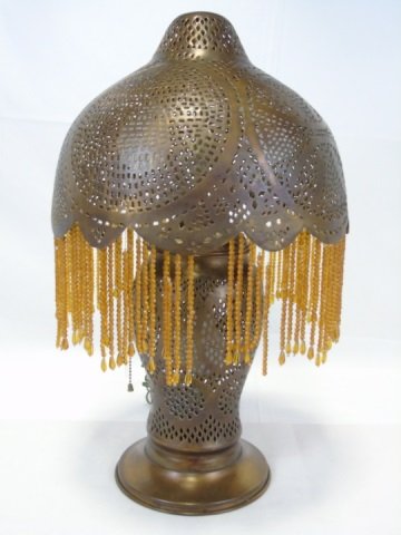 Vintage Moroccan Style Brass Beaded Lamp: Vintage Moroccan style reticulated brass lamp. Shade is adorned with orange bead fringe. 12" diameter x 24" H.
