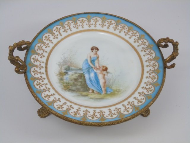 Antique French 19th C Sevres Porcelain Ormolu Bowl: Antique French 19th C Sevres Porcelain Ormolu Bowl / Tazza. Signed on bottom for maker and signed for artist. Gilt bronze ormolu mount with Sevres porcelain at center. Measures 5.5 inches in height, 1