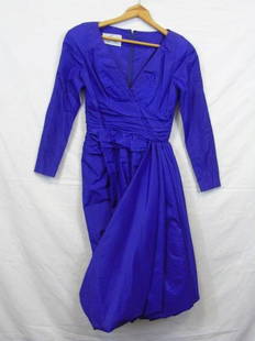 Travilla Silk Taffeta Cocktail Dress Size 6: Vintage purple silk taffeta cocktail dress. Size 6. Zip back. Shirred waist. Pouf skirt hem. Vee neckline. Shoulder to shoulder measures 14". Overall length shoulder to hem is 42". Item needs to be dr