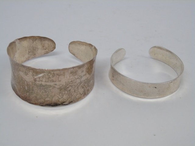 Two Vintage Silver Tone Cuff Bracelets: Two Vintage Silver Tone Cuff Bracelets. Apparently unmarked. Larger measures 2.5 inches wide.