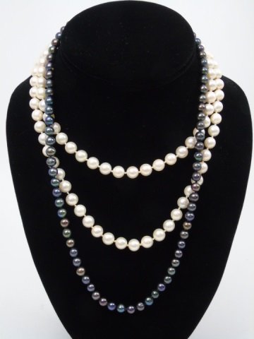 Estate White & Tahitian Pearl 14kt Gold Necklaces: Estate White & Tahitian Pearl 14kt Gold Necklaces. White pearl strand, hand knotted, 14kt gold hallmarked clasp. Tahitian pearl tone beaded necklace with 14kt gold clasp. Longer measures 32 inches.