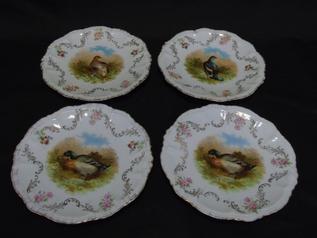 Four Antique German Bavarian Mallard Duck Plates: Four Antique German Bavarian Mallard Duck Plates. Each with a scene of a mallard, duck or fowl at the center with a scrollwork and feathered gilt gold decorated border. Each measures 9 inches in diame