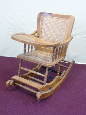 Antique Oak Child's Rocker High Chair: Antique oak child's rocker / high chair. Cane seat and back. Chair converts to a rocker. Table lifts for convenience. 16" W x 27" D x 25 1/2" (as a rocker), 36" H (as a chair). In excellent antique co