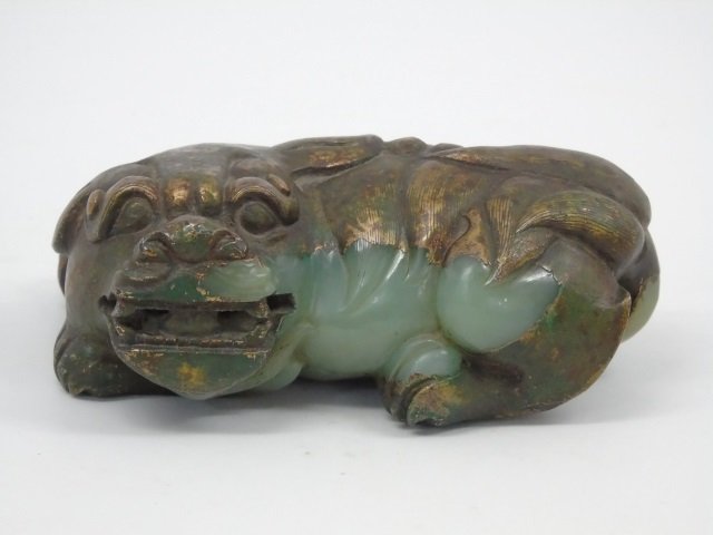Antique Chinese Ming Dynasty Jade Foo Dog: Antique Chinese Ming Dynasty carved jade foo dog. Recumbent figure with bared teeth and flared nostrils. Bronze overlay detail. 4 3/4" W x 3" D x 1 3/4" H.