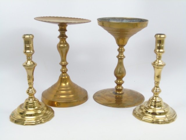 Four Antique English Victorian Brass Candlesticks: Four Antique English Victorian Brass Candlesticks. Pair of candlesticks along with candle stands or trivets. The matching pair are from Colonial Williamsburg. Taller measure 10 inches in height.