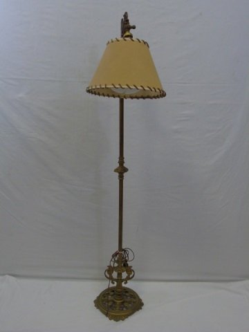 Vintage Brass Standing Lamp w/ Hide Shade: Vintage brass standing lamp. Hide shade has leather whipstitch detail. Top of lamp has ship with sails. Base is very intricate. Base is 10" diameter. Shade is 11" diameter. Height 58".