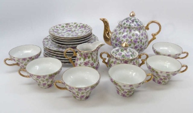 Royal Chintz Bone China Tea / Dessert Set: Royal Chintz bone china tea / dessert set. This lot includes 6 dessert plates, 6 cups, 5 saucers a tea pot and a sugar and creamer. Tea pot is 8" W x 5 1/2" H.