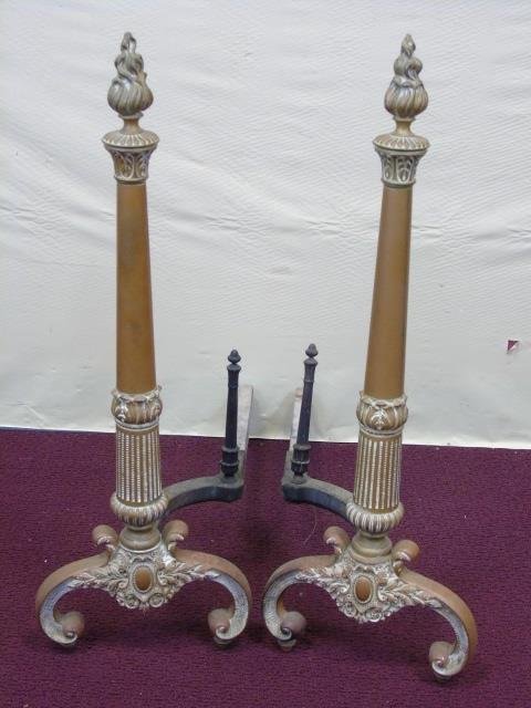 Antique Gilt Metal Fireplace Andirons: Antique Gilt Metal Fireplace Andirons with flame finials. Bottom has cartouche detail. 9 1/2" W x 28"H.