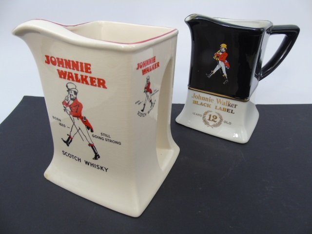 2 Vintage Johnnie Walker Whiskey Pitchers: 2 Vintage Johnnie Walker Whiskey Pitchers. Black and red. Each measures approximately 5.5 inches in height.
