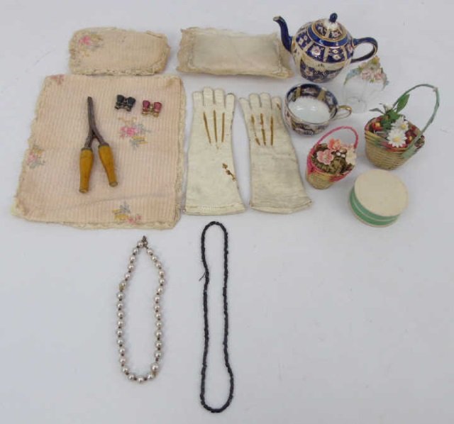 Antique French Fashion Doll Miniature Trousseau: Antique French Fashion Doll Miniature Trousseau Items. Leather gloves, glove instrument, binoculars, necklaces, linens, pillows, perfume bottle, baskets of flowers, hat box. 19th / 20th centuries. Glo