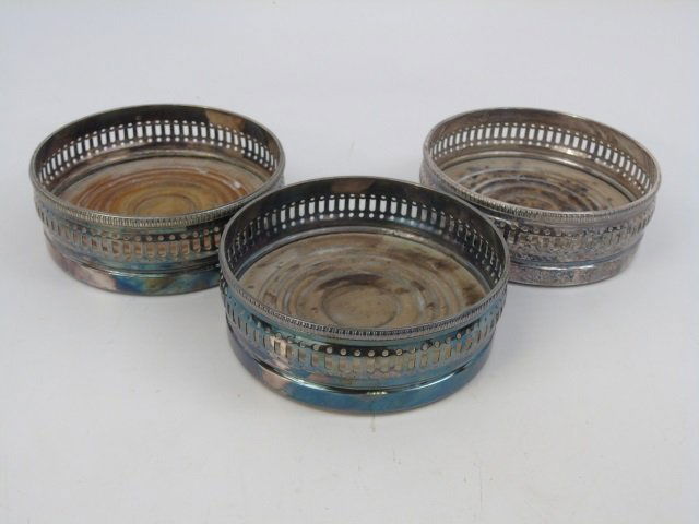 Three Gorham Silver Plate Wine Bottle Coasters: Three Gorham Silver Plate Wine Bottle Coasters. Hallmarked. Silver plate and wood construction. Each measures 5 inches in diameter.