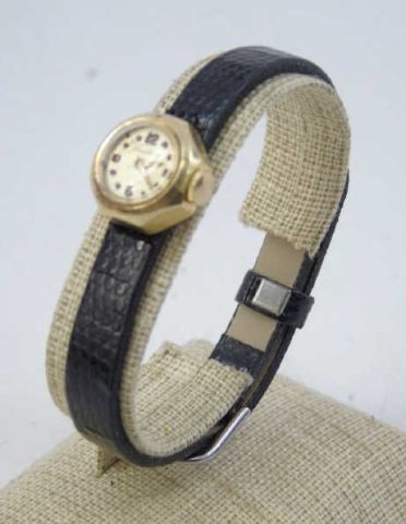 Vintage Ladies 14kt Yellow Gold Wrist Watch: Vintage Ladies 14kt Yellow Gold Wrist Watch. Case marked 14kt. Face marked TRADITION. Black leather band.