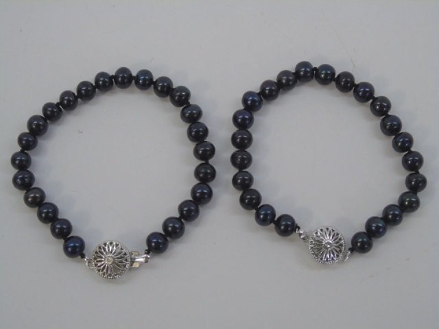 Pair Cultured Black Tahitian Pearl Bracelets: Pair Cultured Black Tahitian Pearl Bracelets w/ Silver Tone Antique Style Filigree Clasps. Each measures just over 7 inches.