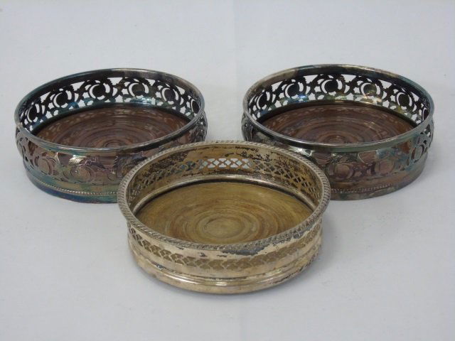 Silver Plate & Wood Wine Bottle Coasters: Silver Plate & Wood Wine Bottle Coasters. Largest approximately 5.5 inches in diameter.