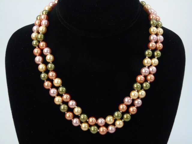 Pair of Cultured South Sea Colored Pearl Necklaces: Pair of Cultured South Sea Colored Pearl Necklaces. Multi color gold, champagne, silver tones. Silver tone clasps. Each measures 17 inches in length.