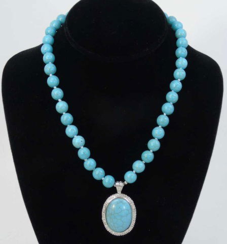 Native American Style Turquoise Necklace w Pendant: Native American Style Turquoise Necklace w Pendant. Silver tone setting and clasp. Hand knotted silk thread. Measures 18 inches in length.