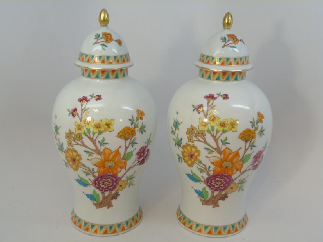 Pair of Bavarian Porcelain Floral Ginger Jars: Pair of Fine Bavarian Porcelain Floral Ginger Jars with Lids. Having unusual trim and use of color, as well as gilt detail. Each measures 13.5 inches high.