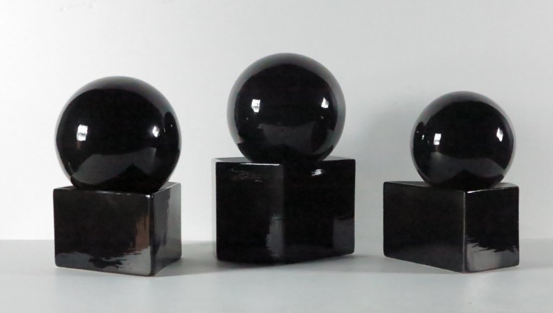 Three Black Glazed Pottery Balls: D. Fetty, 1990, black glazed pottery balls on shaped bases xx