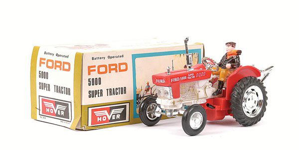 Hover Ford 5000 Super Tractor: Hover Ford 5000 Super Tractor - large scale battery operated Plastic model is red, with White/gold trim, plated parts with rubber tyres and Driver - Near Mint including card box with illustrated lid a