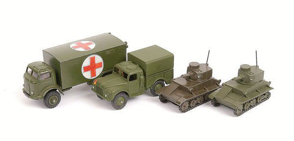 Dinky - A Group of Military Vehicles: Dinky Military a collection of 4 items including - No.152A Post-war Light Tank - military green and (2) another in olive drab. Both with black bases and black chains, (3) No.641 Army 1-ton Cargo Truck