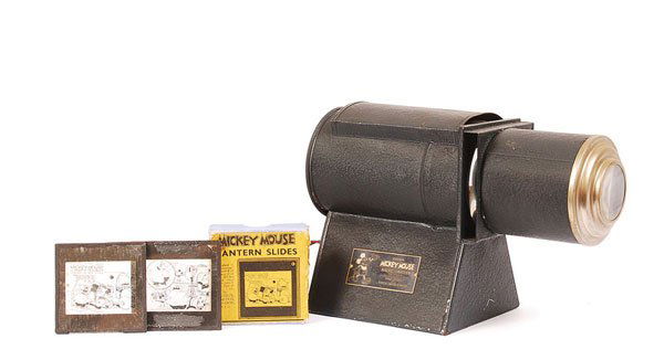 Ensign "Mickey Mouse" Magic Lantern: Ensign "Mickey Mouse" Magic Lantern, made in England in black metal, electrically lit. Produced by arrangement with Walt Disney by Ensign Ltd. Complete with Series of 3" x 3" lantern slide in original