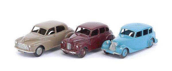 Dinky - A Group of 1950s Cars: Dinky a group of 1950s Cars. (1) Triumph - mid blue including ridged hubs, (2) Morris Oxford - beige, grey ridged hubs and (3) Austin Devon - maroon, including ridged hubs - Good Plus to Excellent Plu