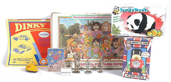 A Mixed Group of Toys: A mixed group of items. To include The Beatles illustrated lyrics puzzle, Parade Guard Alarm Clock, battery operated Panda, wooden pullalong Train Set with wooden soldier figures, Dinky Toys Calendar