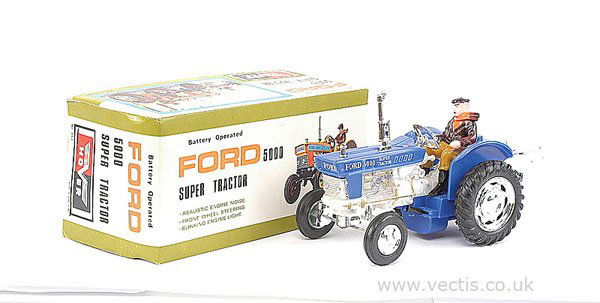 Hover (Hong Kong) Ford 5000 Super Tractor: Hover (Hong Kong) Ford 5000 Super Tractor - ex shop stock model is blue, with plated parts, includes driver and rear equipment attachment - Mint including illustrated box, 21cm.
