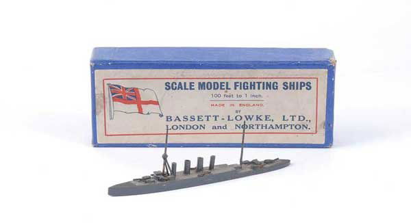 Bassett-Lowke HMS "Nottingham": Bassett-Lowke wooden Waterline Ship HMS "Nottingham". Built to 1/1200th scale and finished in battleship grey with Bassett Lowke label to base. A little dusty, minor paint loss to one funnel else Exce