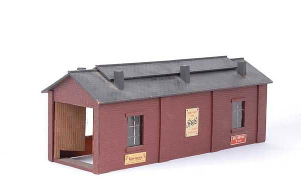 Bassett-Lowke/Mills Single Road Engine Shed: Bassett-Lowke/Mills or similar O Gauge single road Engine Shed measuring 18 1/2" x 6" with a number of enamel signs attached including Bass, Gaymers, Stephens Inc, Whitbread's and 3 others. Sides and